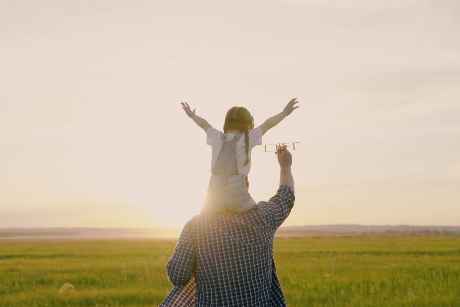 Happy family dad, baby, daughter play together with toy plane